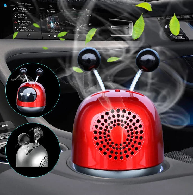 Blue robot car decorative ornament clipped to a car air vent as an aromatherapy diffuser.
