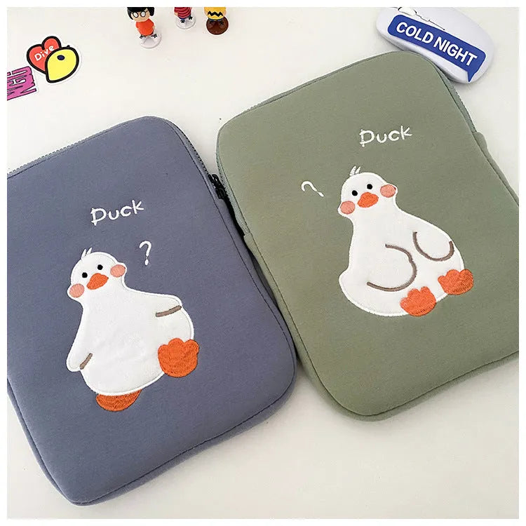Blue cotton tablet case with embroidered cartoon duck design and zipper closure for device protection