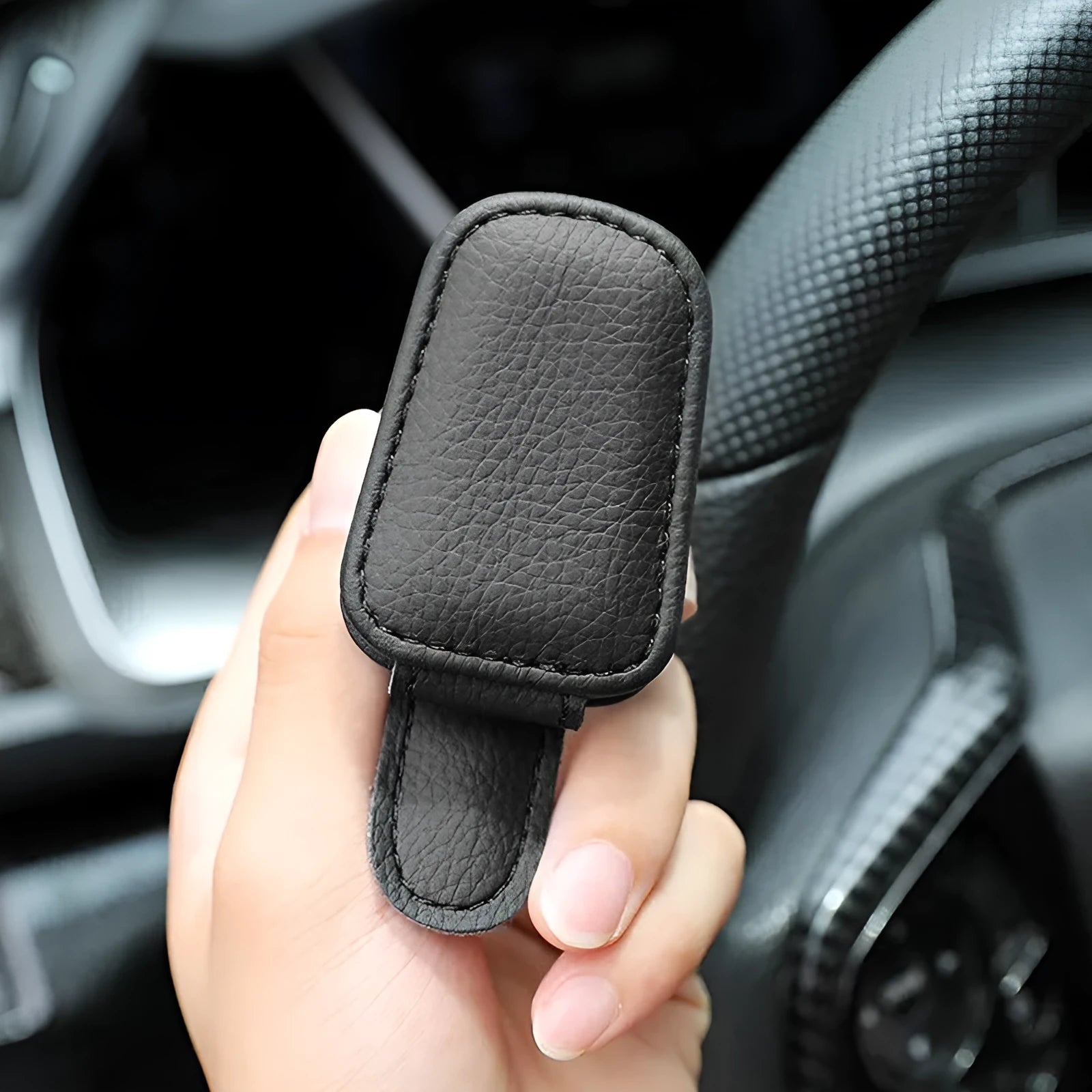Car sunglasses holder clip with PU leather case attached to vehicle sun visor