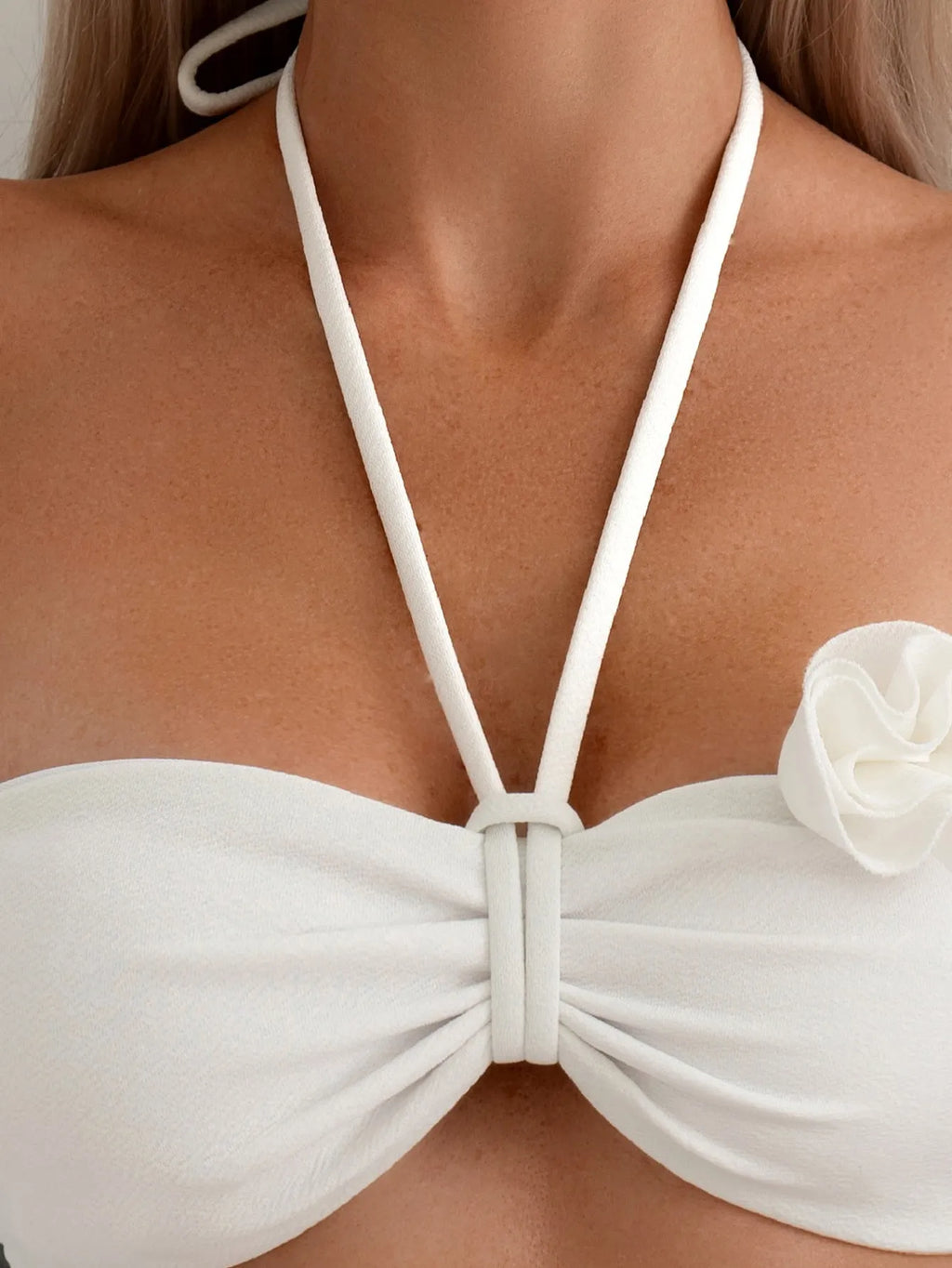 White halter neck bikini with lace-up back and three-dimensional flower detailing for swimming