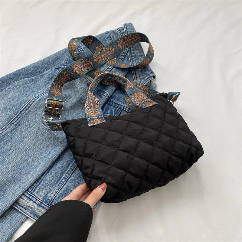 A soft oxford cloth shoulder messenger bag in a horizontal square shape with a single strap.