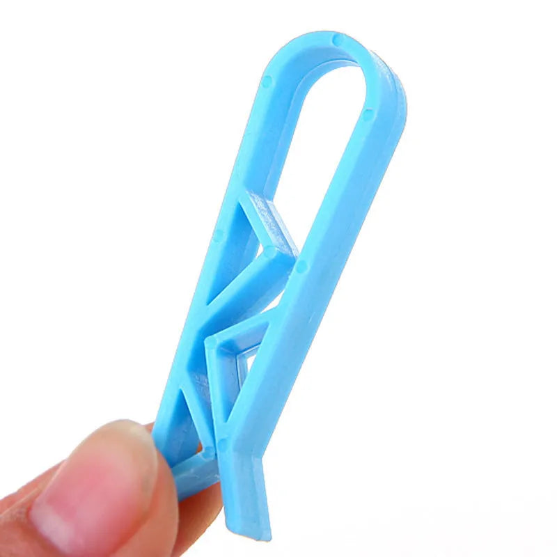 Black plastic non-slip clip for holding bin bags on the side of a trash can.