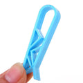 Black plastic non-slip clip for holding bin bags on the side of a trash can.