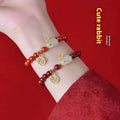 Cinnabar hare bracelet with purple gold sand beads on a wrist, showing retro jewellery style.