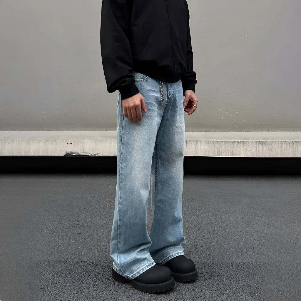 Men's blue straight-leg jeans with whisker wash detailing and a flared leg.