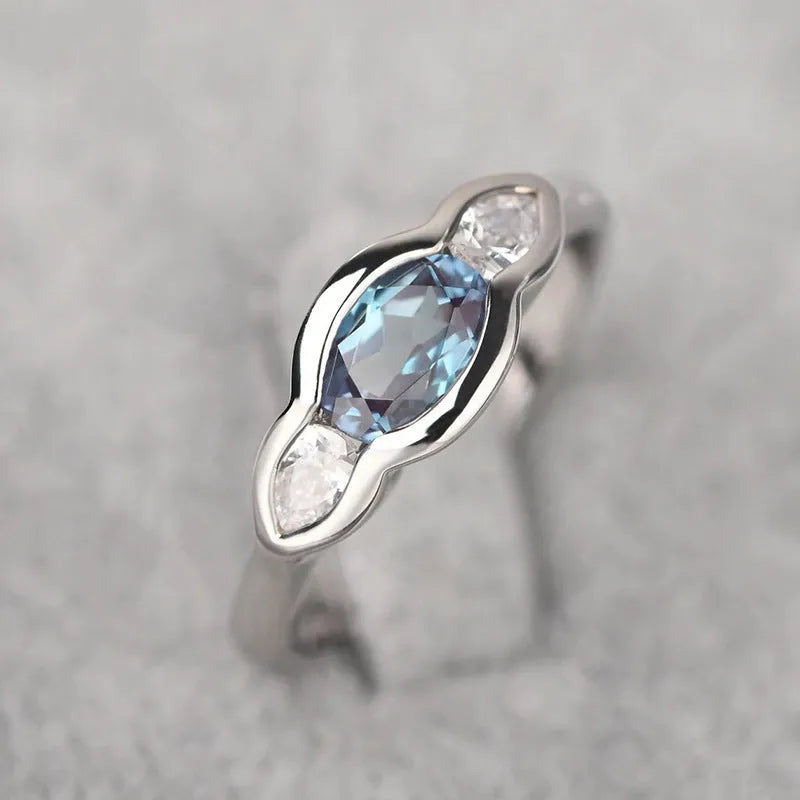 Geometric ellipse copper ring with zircon inlay, white gold colour finish, shown in size options 6-10