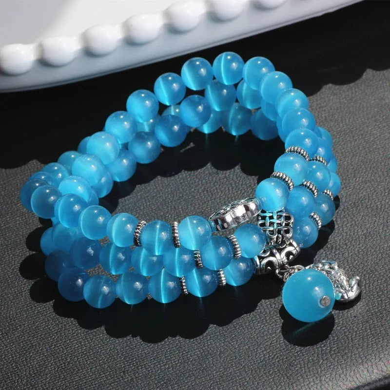 Opal crystal three-ring bracelet with geometric shapes and cat eye detailing in blue colour option
