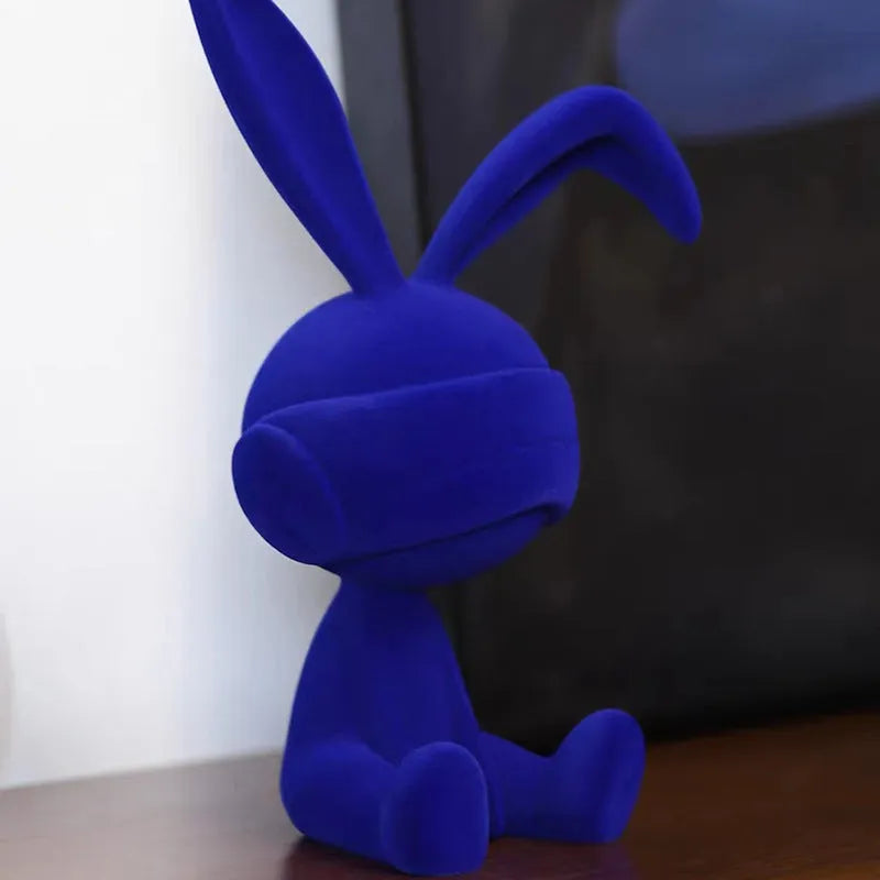 Green suede blindfold rabbit resin ornament on a wooden table, 15cm tall