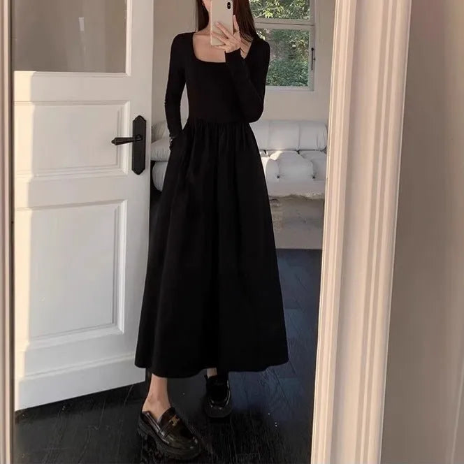 Women's black square collar knitted dress with elastic waist and long A-line skirt, made from polyester fabric.