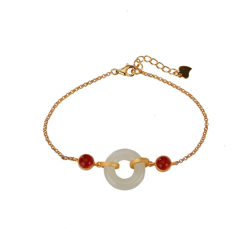 Gold-coloured women's bracelet with a silver base and an inlaid green Hetian jade charm, showing a peace buckle clasp.