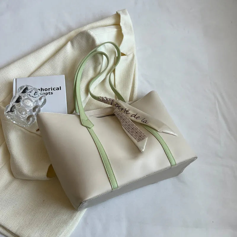 Soft tote bag with crossbody strap showing internal zipper compartment and khaki colour option