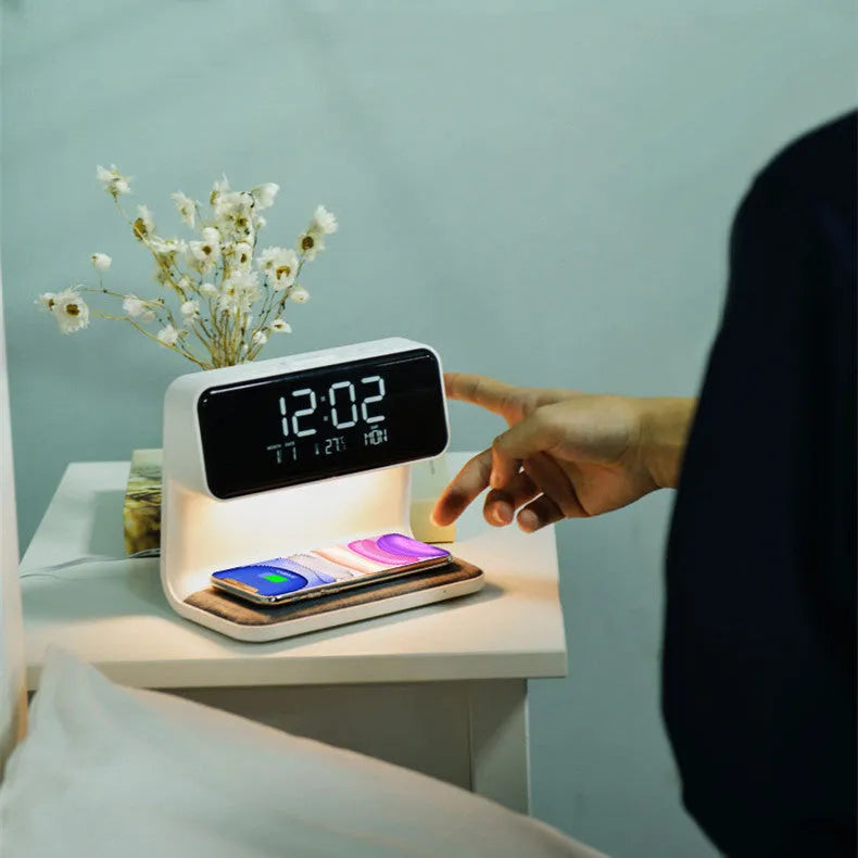 White bedside lamp with integrated wireless charging pad, LCD alarm clock screen, and touch-sensitive dimming controls.