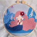 Beginner embroidery craft kit showing cartoon animal patterns including turtle, sheep, and butterfly on cloth