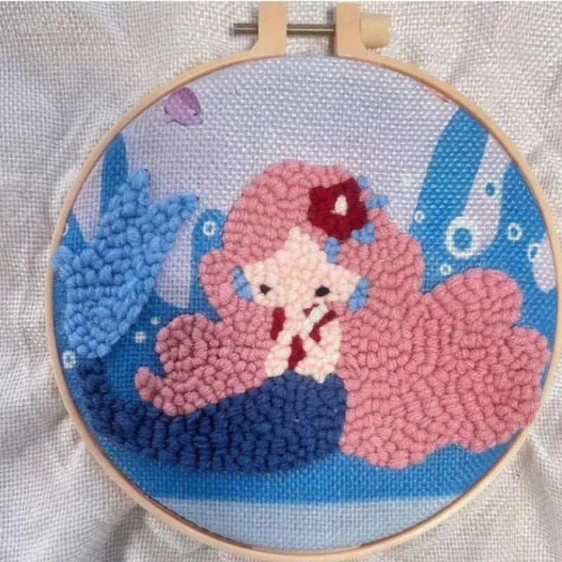 Beginner embroidery craft kit showing cartoon animal patterns including turtle, sheep, and butterfly on cloth