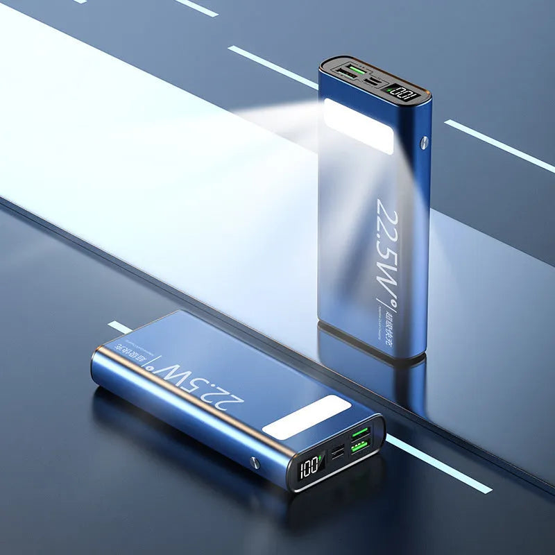Black alloy power bank showing LCD display and USB ports on a grey background.