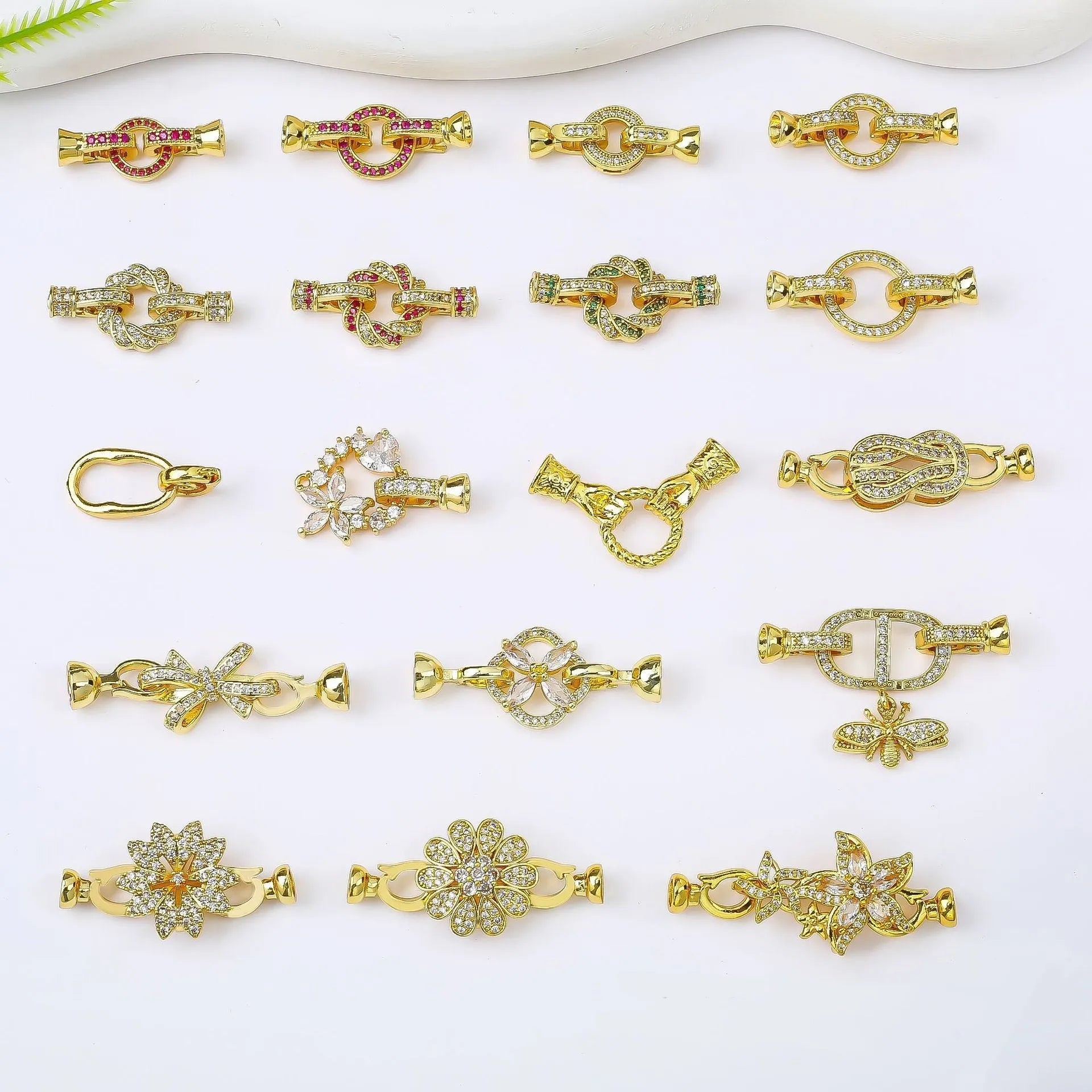 Small gold colour necklace clasp chain buckle on a white background