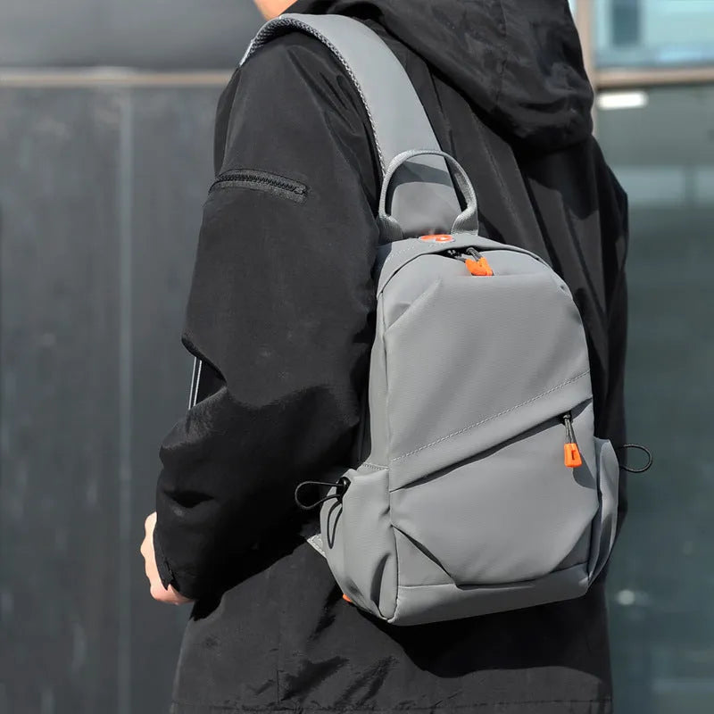 Black mens crossbody bag with adjustable strap showing waterproof polyester material