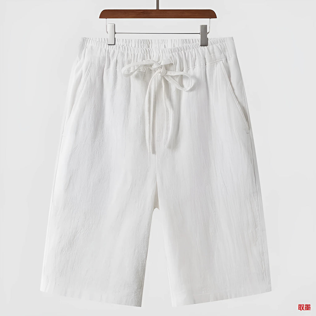 Men's loose linen shorts in beige colour with cropped length and elastic waistband