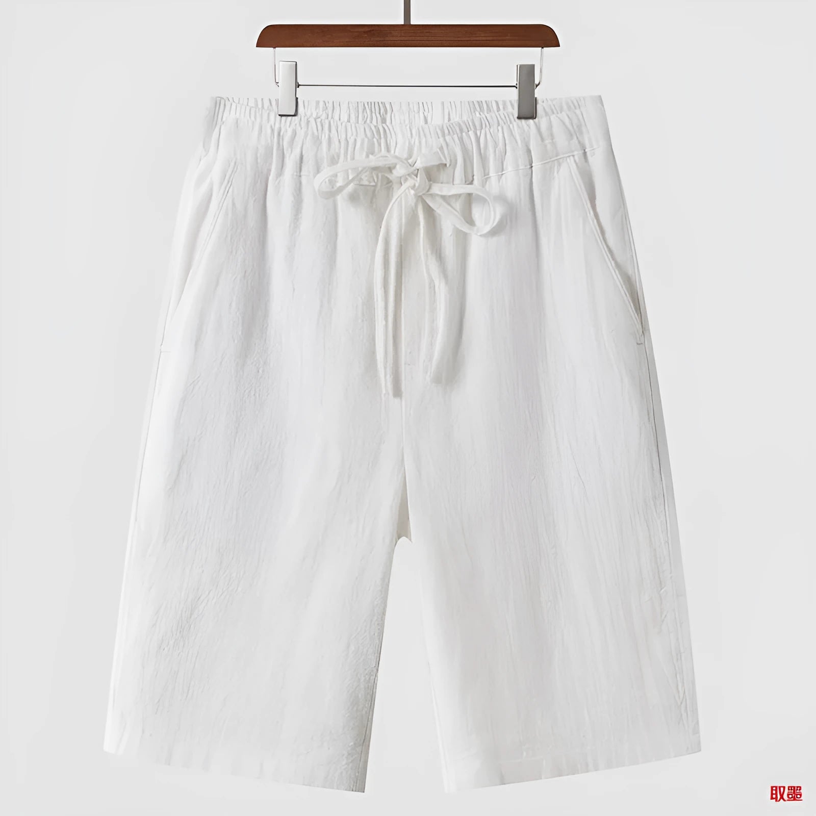 Men's loose linen shorts in beige colour with cropped length and elastic waistband