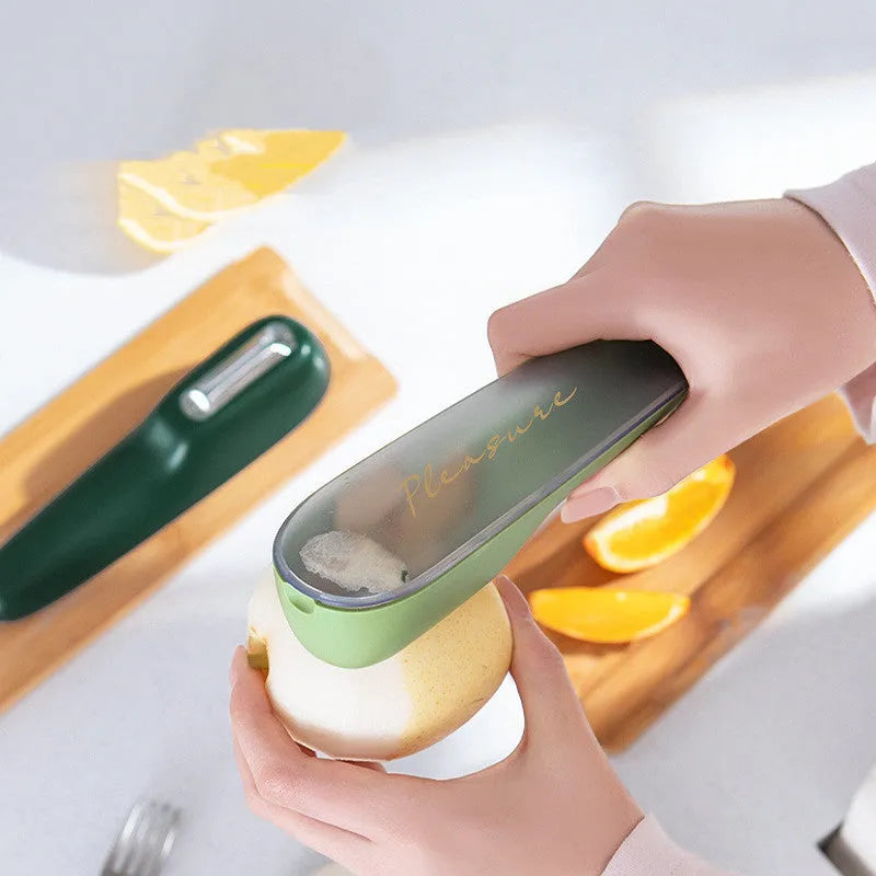 Green kitchen peeler with storage tube and stainless steel blade for fruit and vegetables