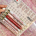 Five nurse theme ballpoint pens with humorous decoration arranged together