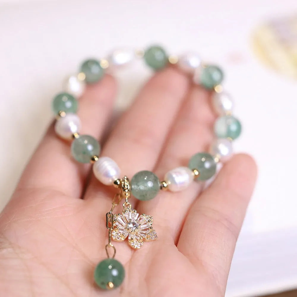 Green strawberry-shaped freshwater pearl bracelet with Chinese knot closure and small flower pendant