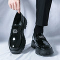 Men's black glossy PU leather loafers with a low platform sole, shown in a summer setting.