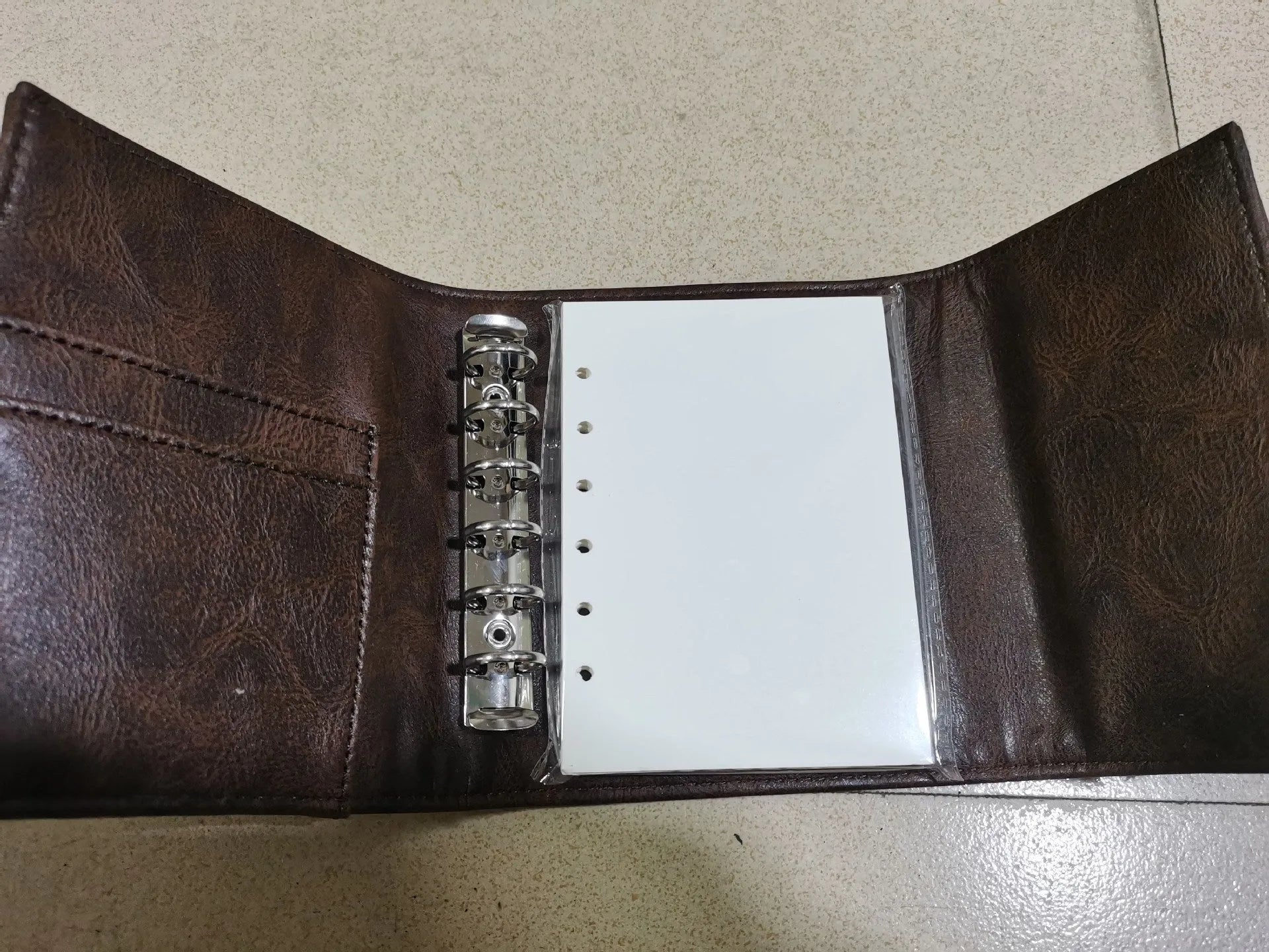 A7 brown PU notebook with loose-leaf binder binding showing 40g raw wood pulp paper inside