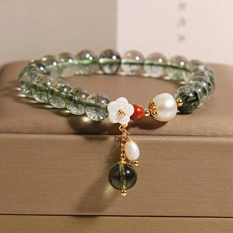 Green phantom quartz crystal bracelet with small bells of Ireland design and shell flower accents