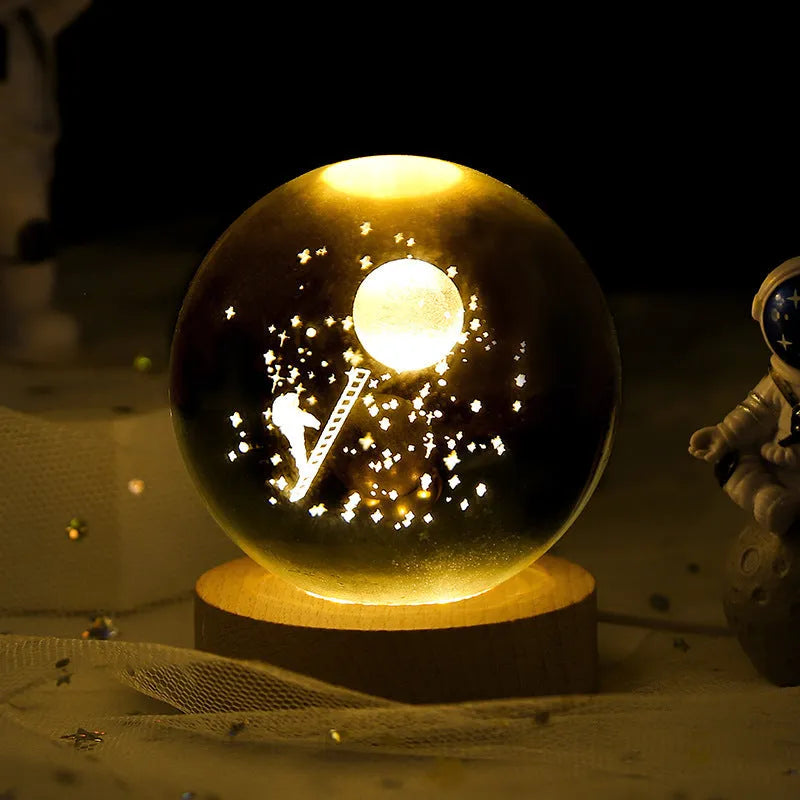3D crystal ball night light projecting starry sky and planets from its 6cm sphere on a solid wood base.