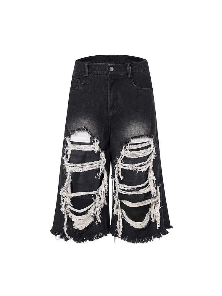 Black cropped wide-leg jeans with mid-high waist, showing loose fit and micro-elastic cotton fabric