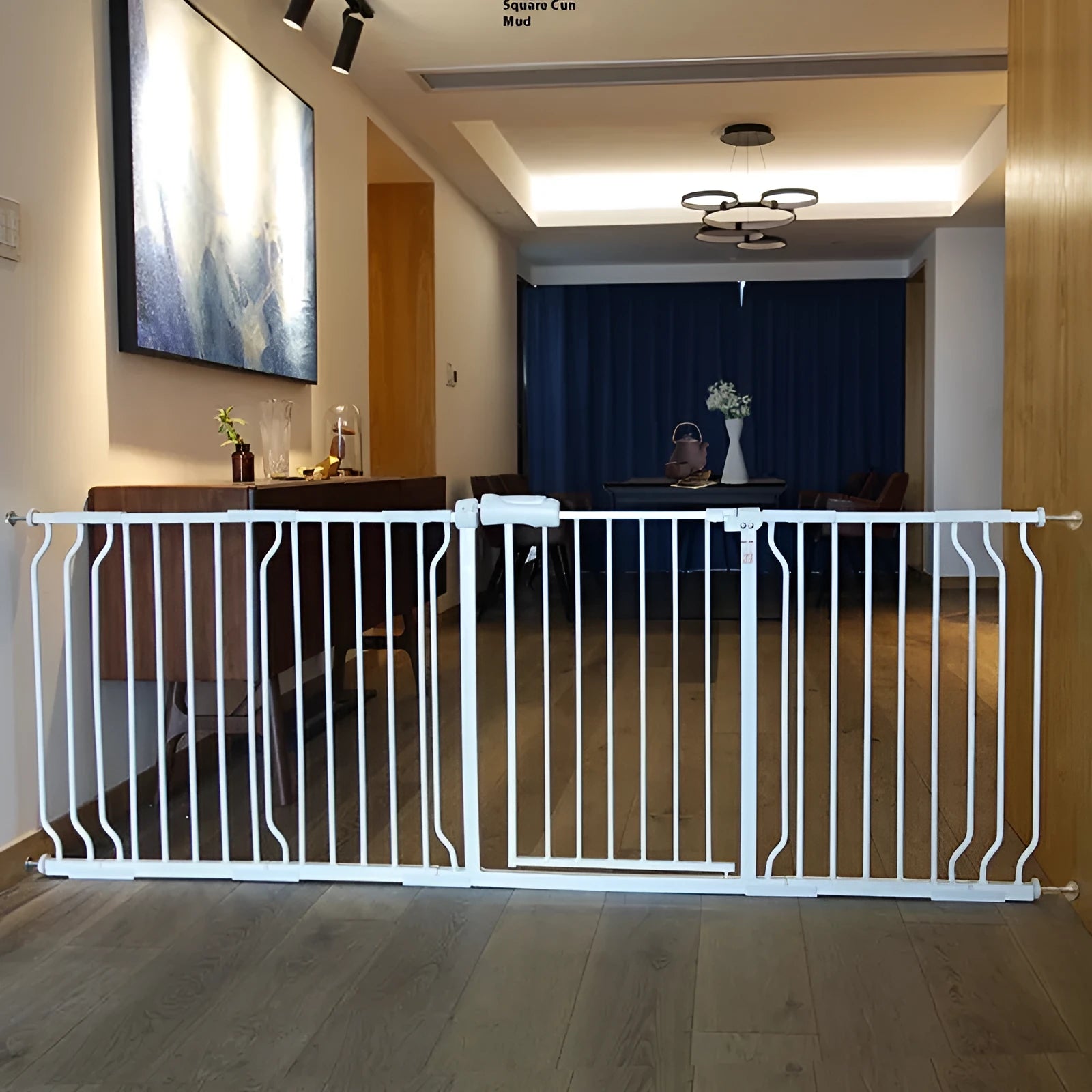 White plastic baby safety gate installed at top of stairs with 78cm height and adjustable width mechanism