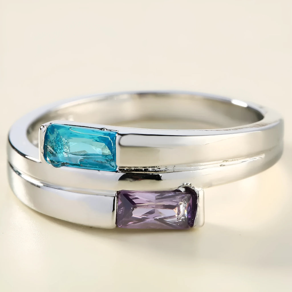 Silver-coloured copper ring with a central zircon stone, shown on a hand.