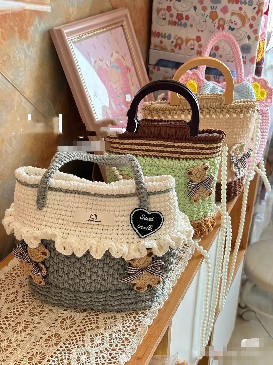 Wool crocheted bear shoulder bag with wooden handle showing crochet texture detail