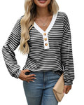 A woman's loose-fitting V-neck pullover top with long sleeves and patchwork detailing.