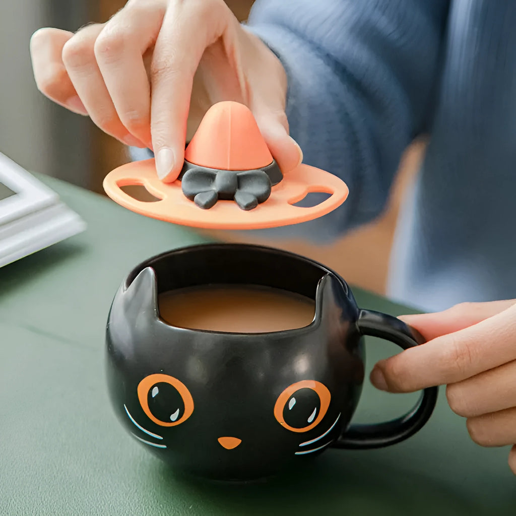 Black ceramic novelty mug with Halloween pumpkin, spoon couple, and cat design, 355ml capacity.