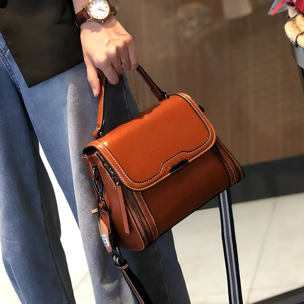 Women's brown genuine oil wax leather messenger bag with double shoulder straps and visible sewing lines