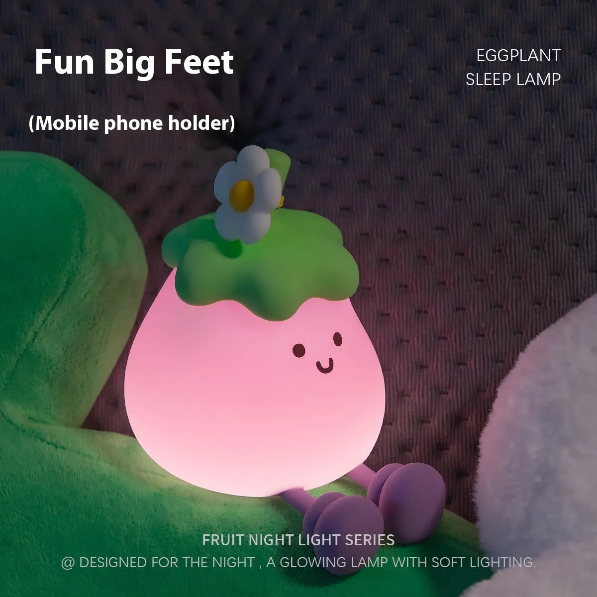 Cartoon-shaped eggplant night lamp glowing with soft yellow light on a table.
