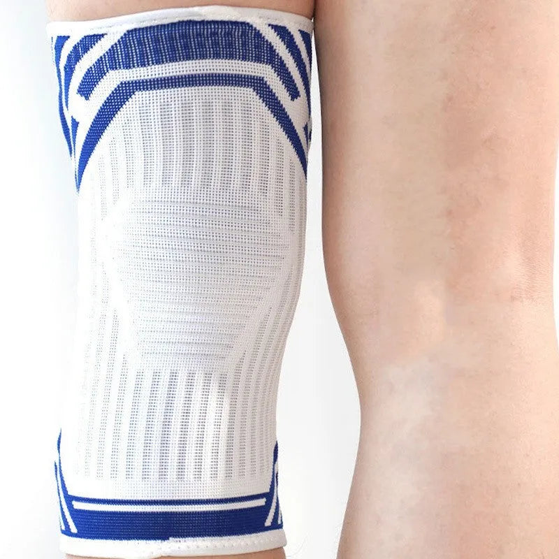 Blue elastic cotton knee pad for adults, shown on a knee for basketball or running sports.