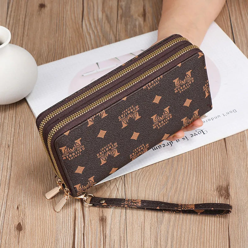 Retro style long wallet clutch in PU leather with a print design, shown in black colour.