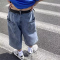 Men's blue washed denim shorts with high waist, cropped length, and straight-leg design on a model