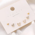 Three pairs of heart-shaped alloy earrings with electroplating in gold, black, black-white, and pink colours