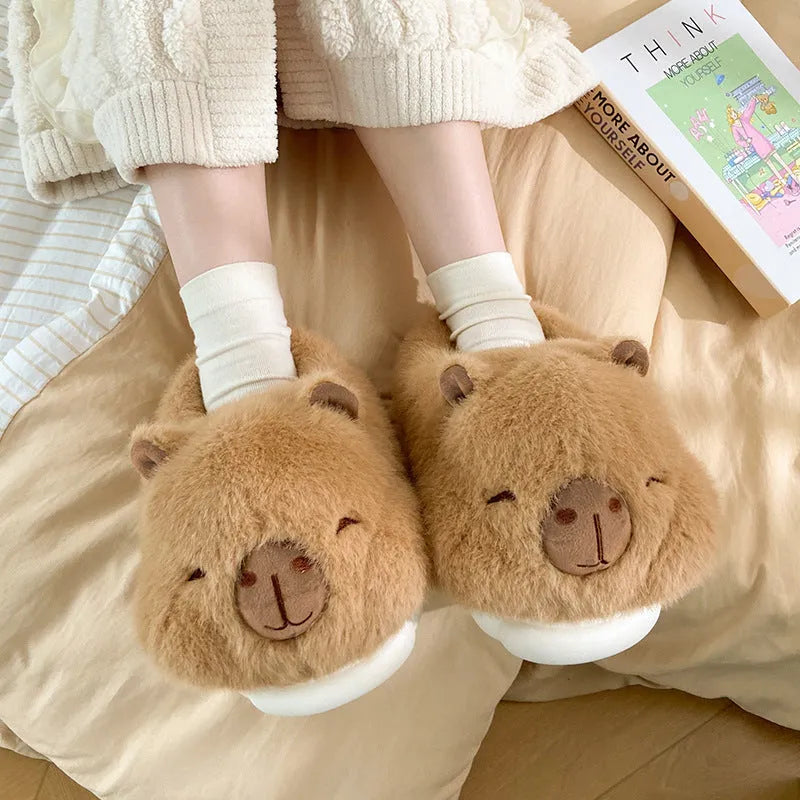 Light brown women's fleece slippers with a cartoon pattern, artificial wool lining, and a PVC sole.