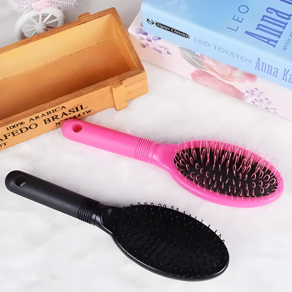 Black and pink ring tooth airbag comb for hair extensions on a white background