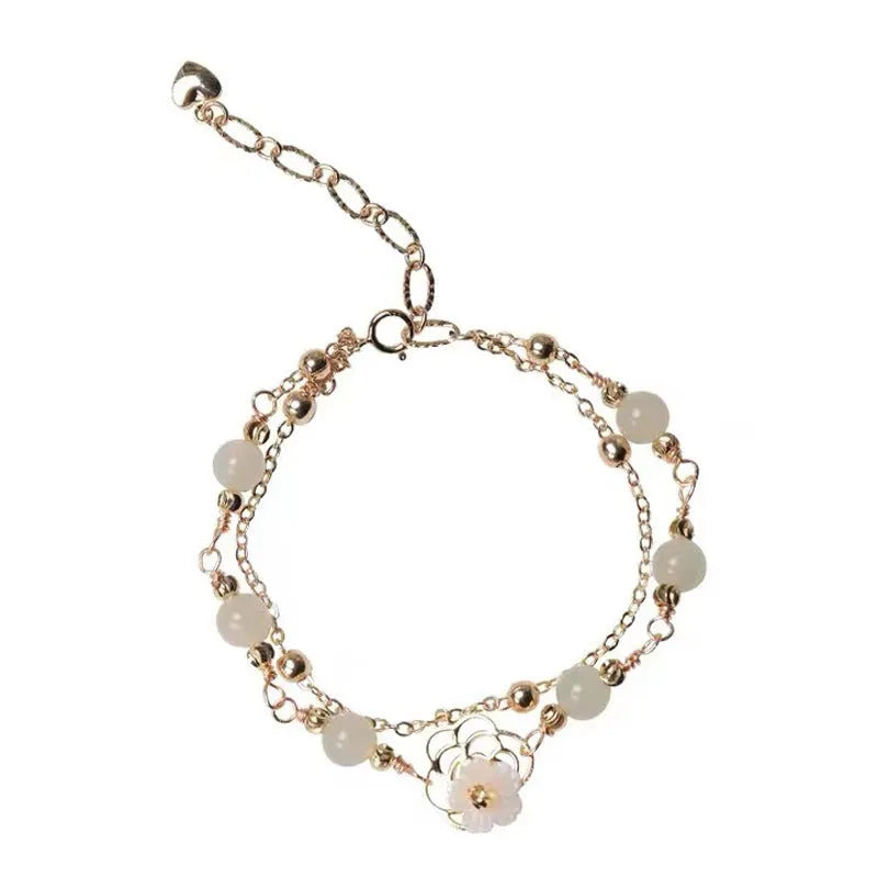 Yellow gold electroplated copper bracelet with butterfly charm and geometric shape for women.