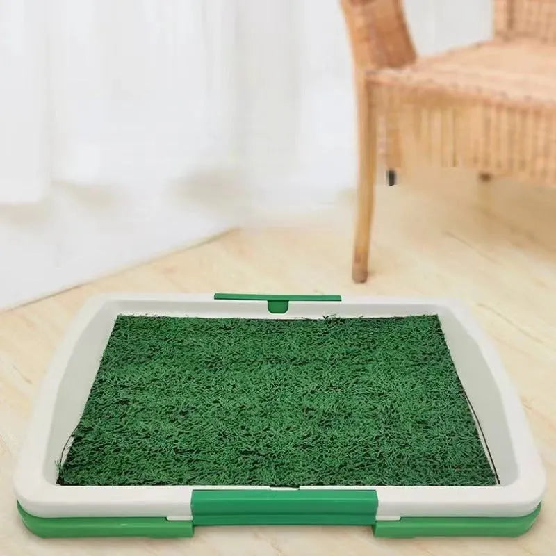 Green artificial grass dog toilet training tray with three-layer construction on a balcony.