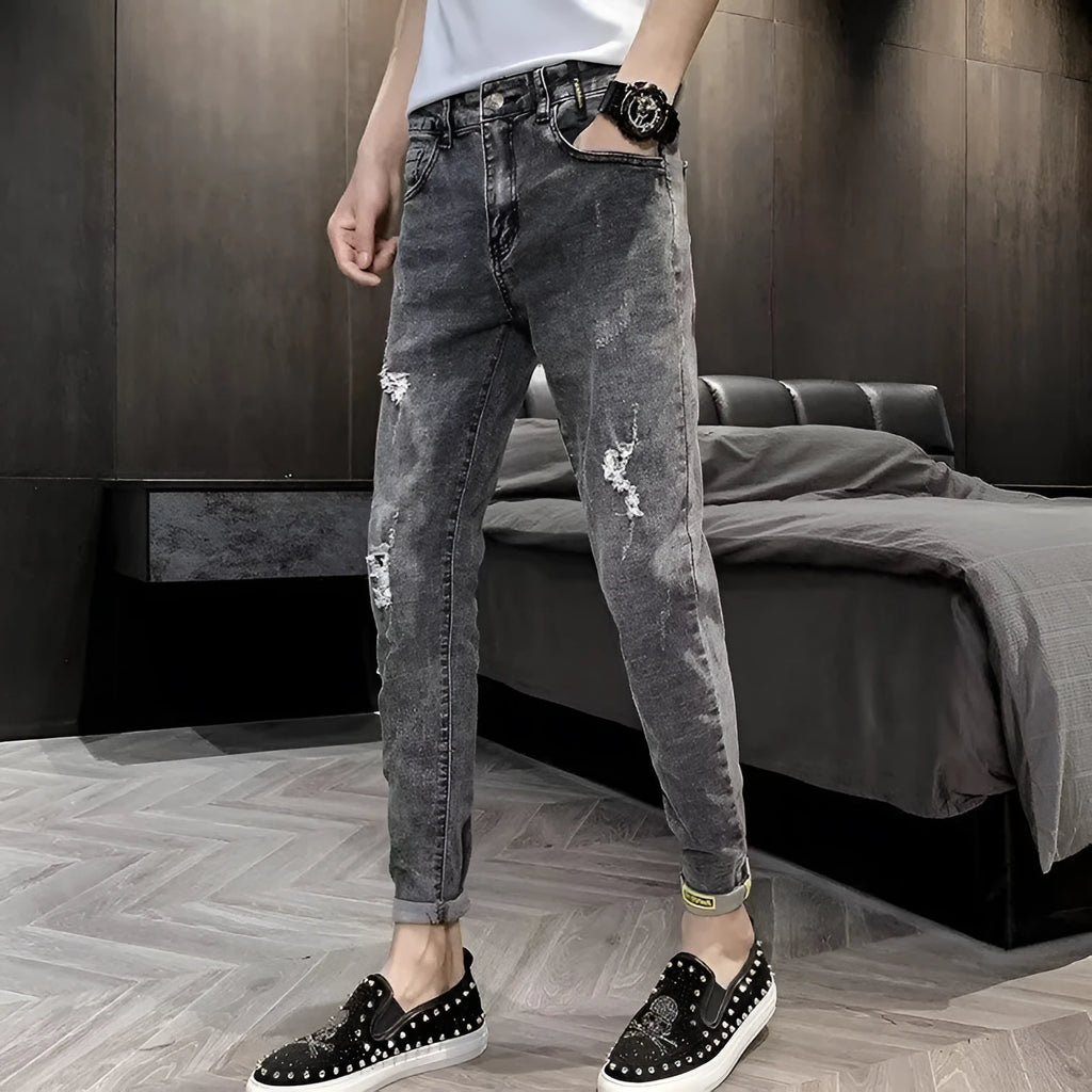 Men's high-waisted cotton denim jeans in a basic style with a button fly.