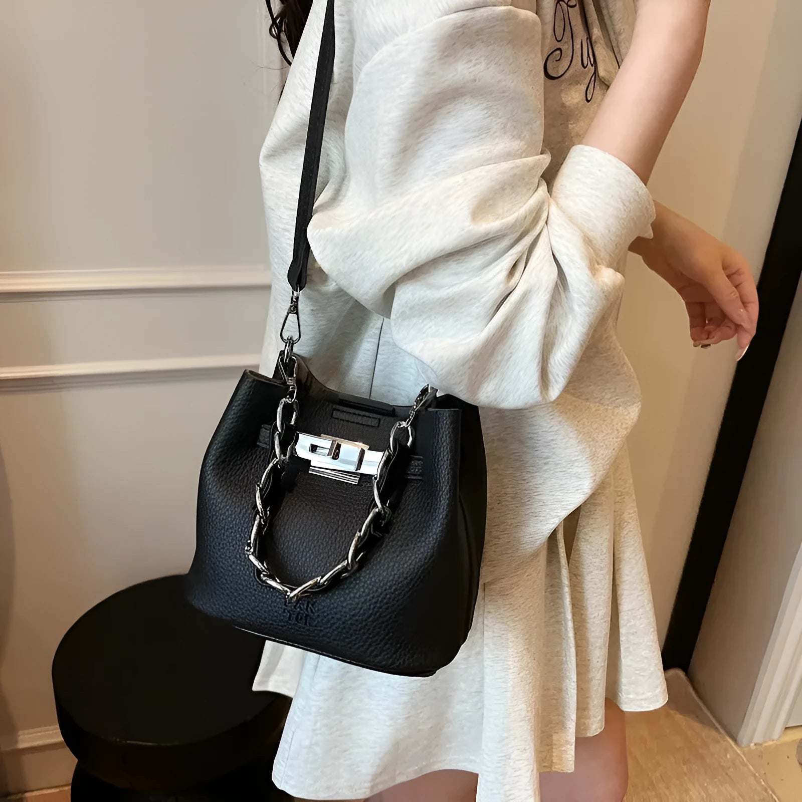 Soft black PU leather retro bucket shoulder bag showing interior phone and zipped pockets.