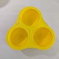Yellow silicone dog toy ball with textured surface for dental cleaning and treat dispensing function