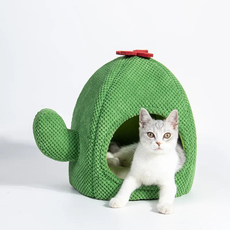 Green cactus-shaped enclosed cat bed with soft fluffy fabric and a plush interior for pets.